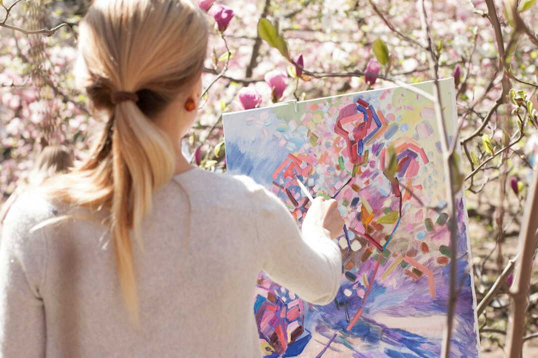 woman painting on canvas