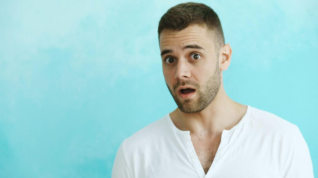 Brazilian man speaking confidently with open hand gesture
